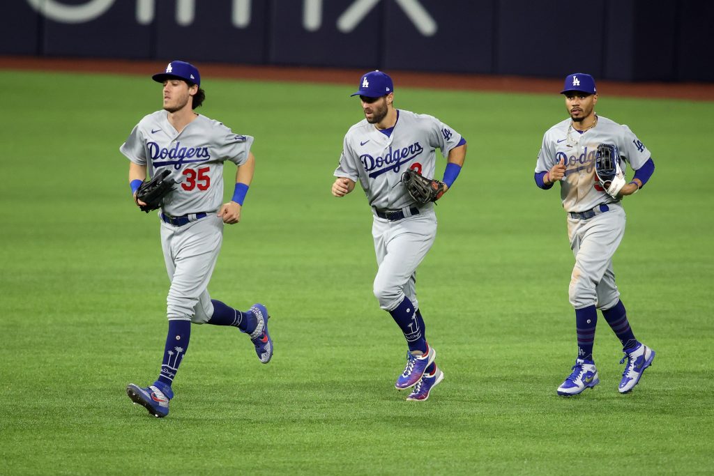 Los Angeles Dodgers outfielders Mookie Betts, Cody Bellinger, and Chris Taylor jog in during World Series against Tampa Bay Rays