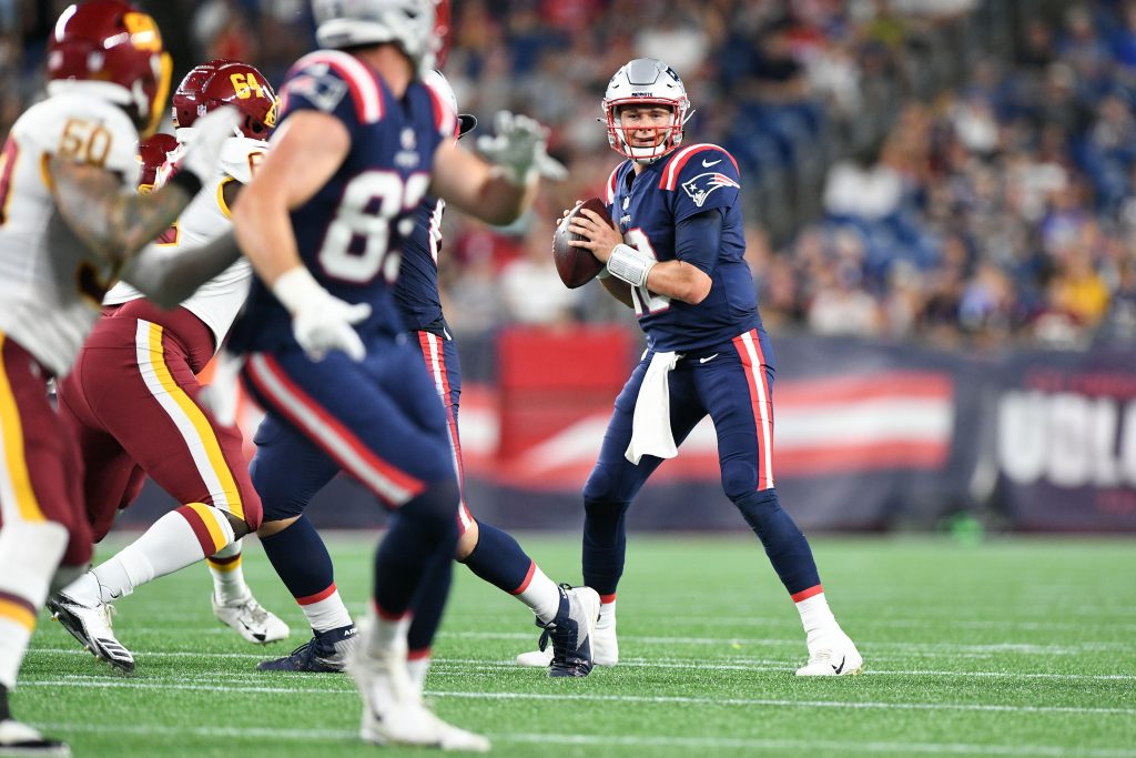 New England Patriots quarterback Mac Jones 10) looks to throw against the Washington Football Team during the second half of a preseason game at Gillette Stadium