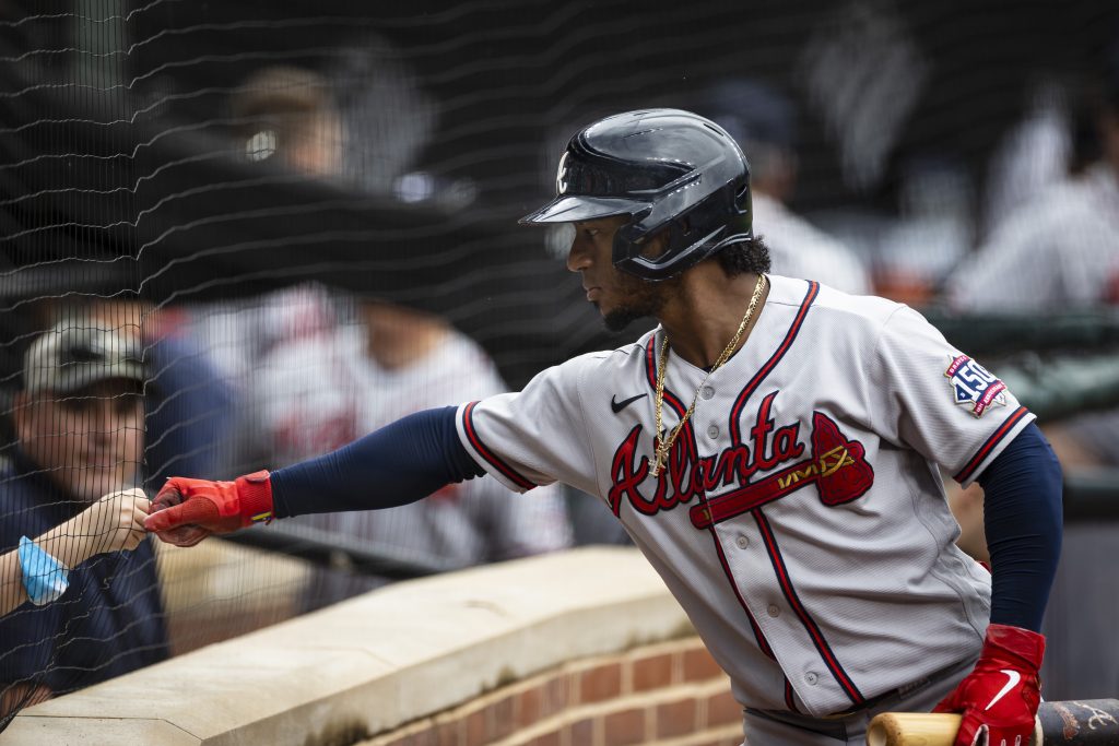 Atlanta Braves second baseman Ozzie Albies (1) first bumps a young fan during the first inning against the Baltimore Orioles at Oriole Park at Camden Yards