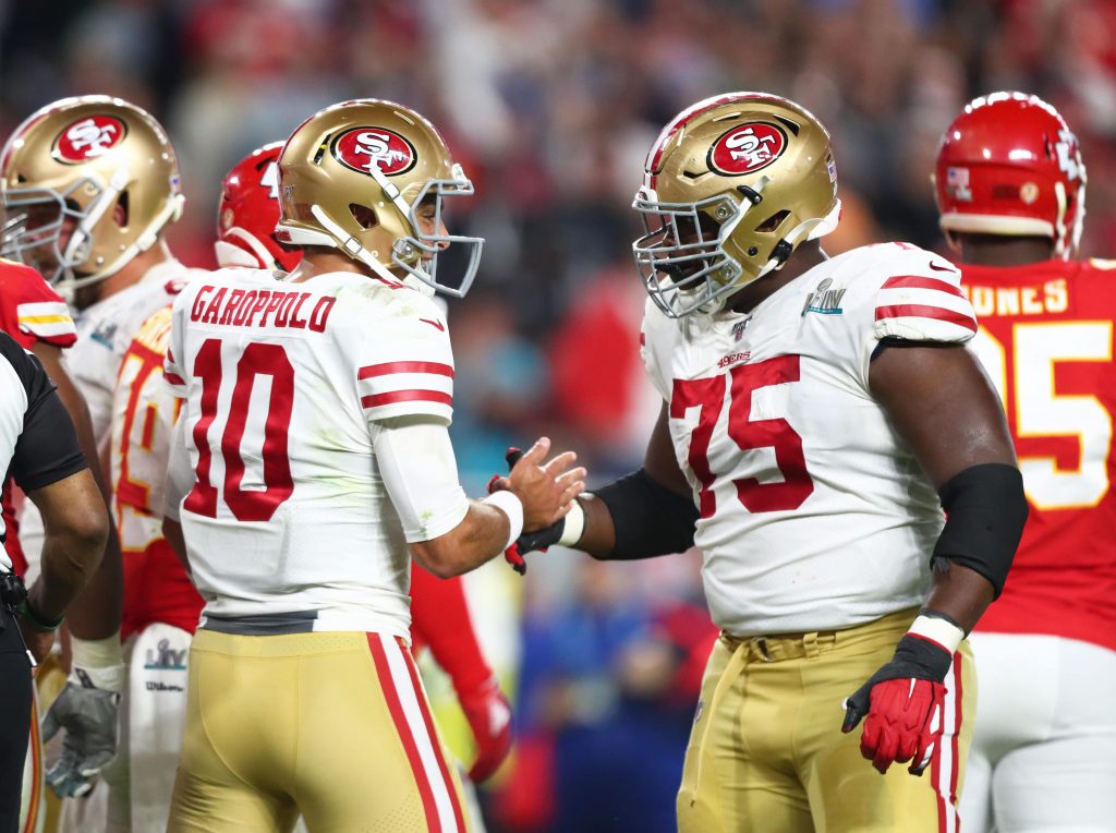 San Francisco 49ers quarterback Jimmy Garoppolo (10) celebrates a play with guard Laken Tomlinson (75) during Super Bowl LIV against the Kansas City Chiefs at Hard Rock Stadium.